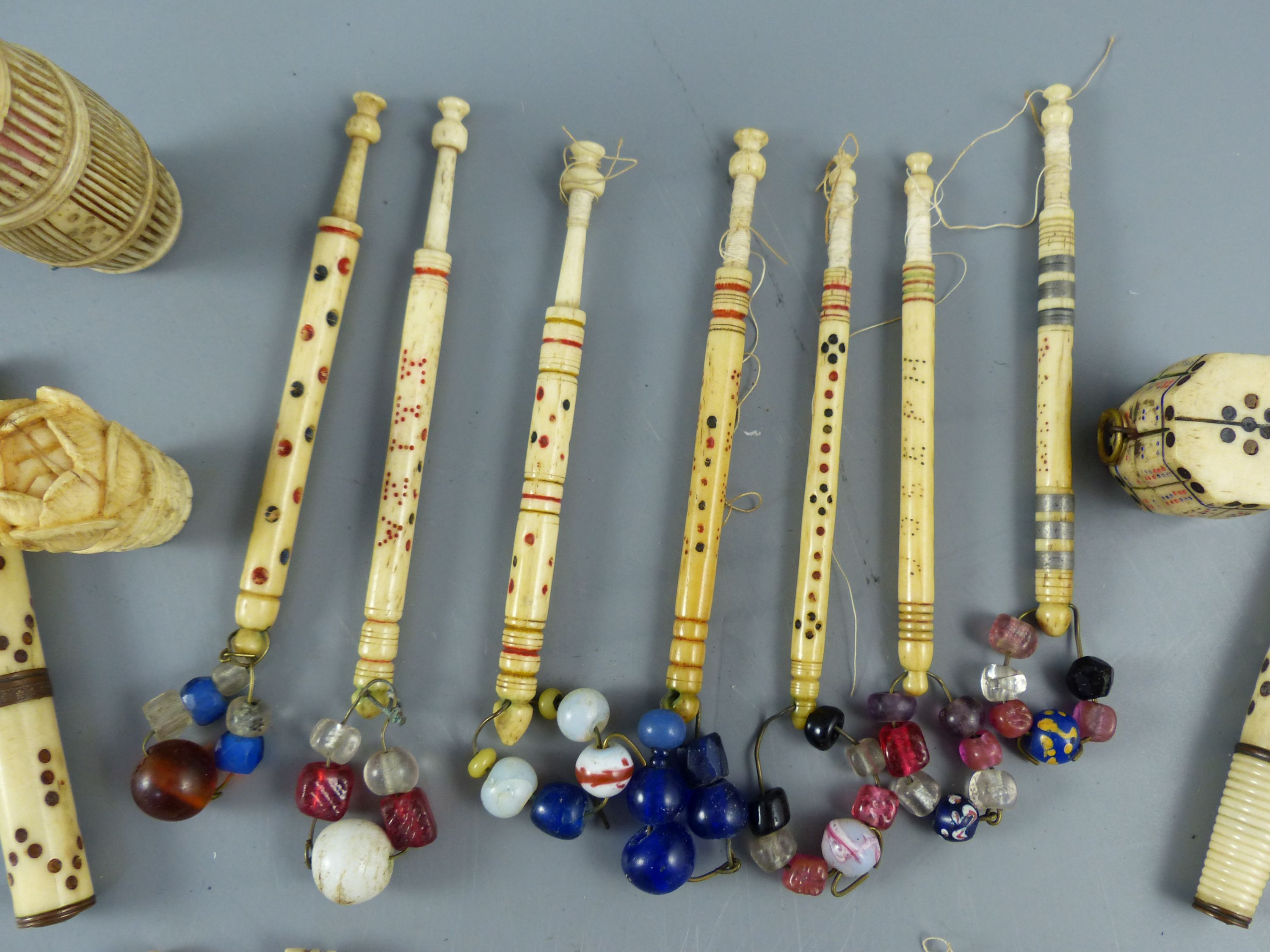 A collection of assorted 19th century stained ivory and bone sewing implements